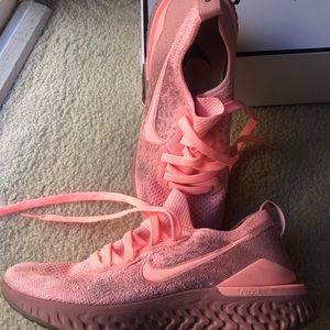 Bright pink Nike epic fly react shoes